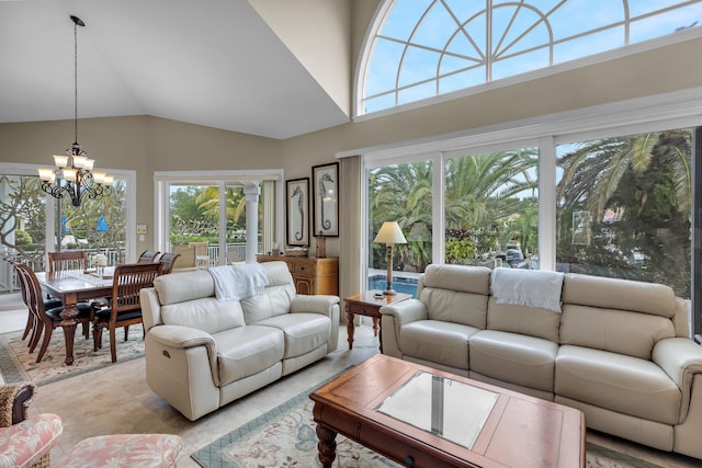 living area featuring high vaulted ceiling and a chandelier