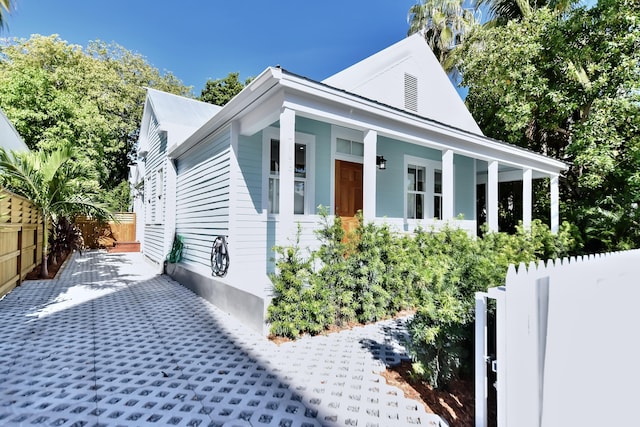 view of front facade featuring a porch and fence