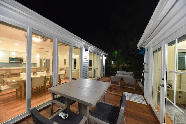 deck at twilight featuring french doors and an outdoor living space