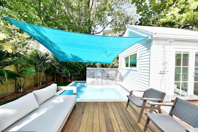 view of pool with a fenced backyard, an outdoor hangout area, a deck, and french doors