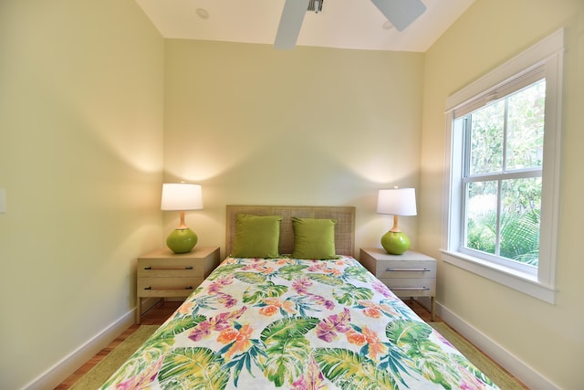 bedroom with baseboards and multiple windows