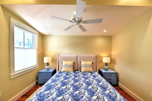 bedroom featuring baseboards, dark wood finished floors, and ceiling fan