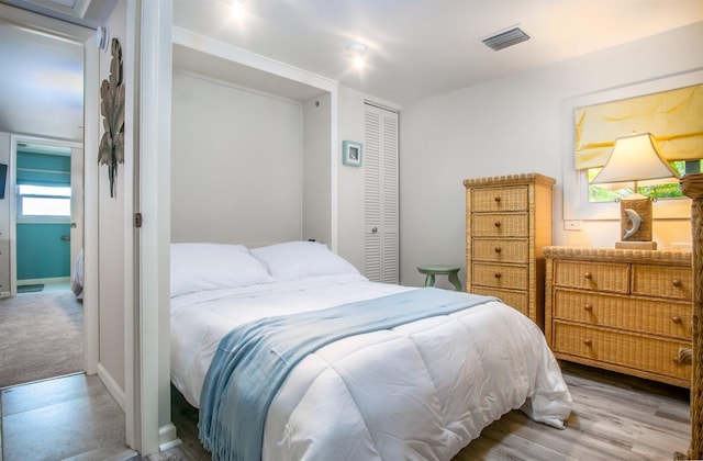 bedroom with wood-type flooring and a closet