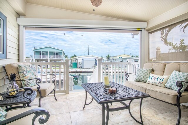 sunroom / solarium featuring lofted ceiling