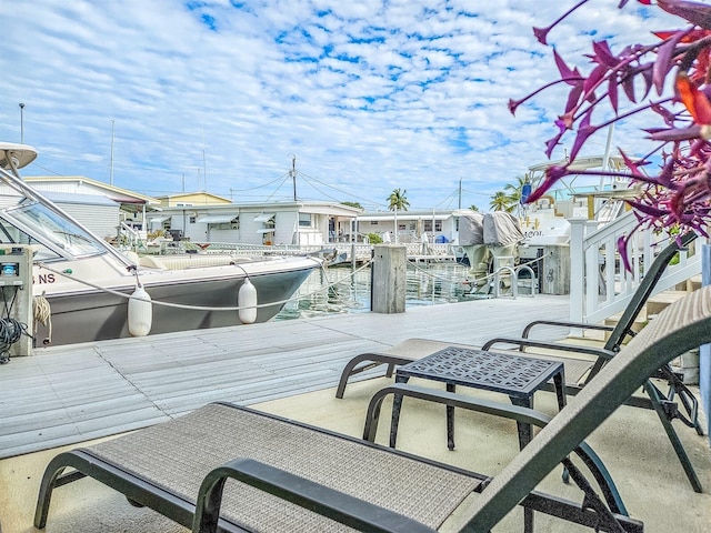 view of patio / terrace with a water view and a dock