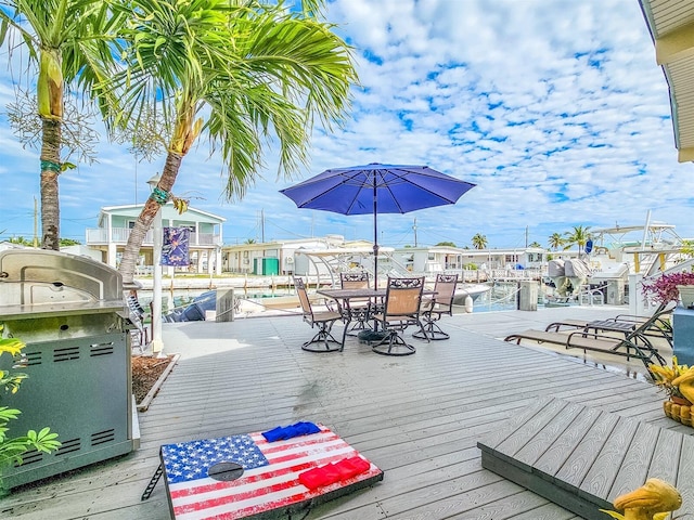 deck with area for grilling and a dock