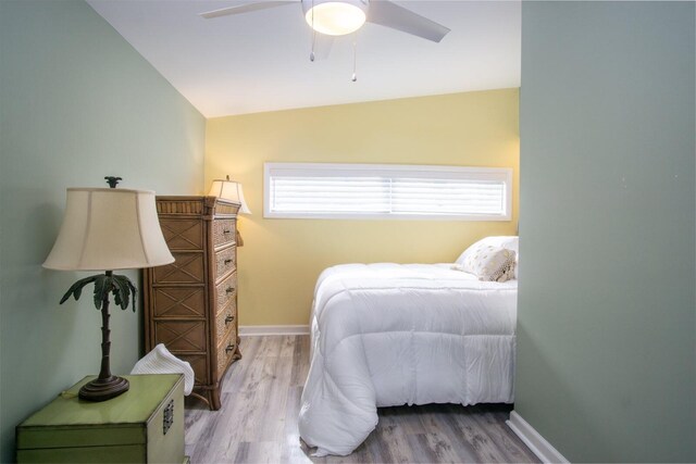 bedroom featuring vaulted ceiling, ceiling fan, and light wood-type flooring