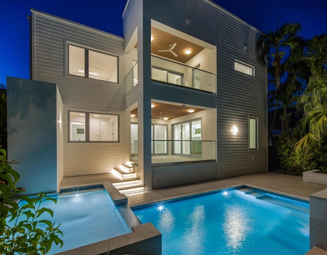 1614 Washington St, Key West, FL 33040 - back of house at twilight with a patio area, an outdoor pool, and stucco siding