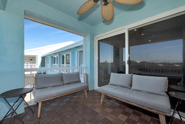 sunroom featuring ceiling fan