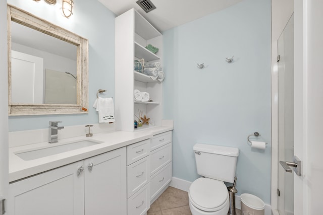 bathroom featuring tile patterned flooring, vanity, and toilet