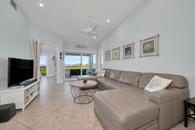 tiled living room with high vaulted ceiling and ceiling fan