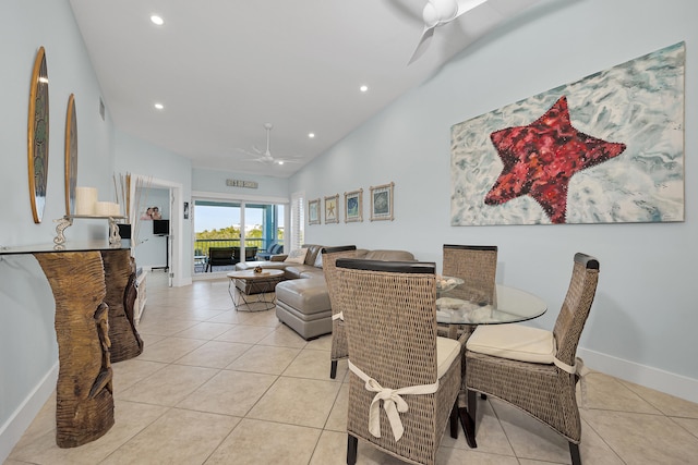 tiled dining area with a towering ceiling and ceiling fan