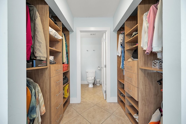 spacious closet with light tile patterned floors