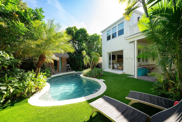 view of swimming pool with a yard and a patio