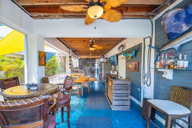 exterior space featuring concrete flooring and a ceiling fan