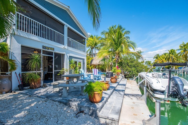 exterior space with a boat dock and a patio area