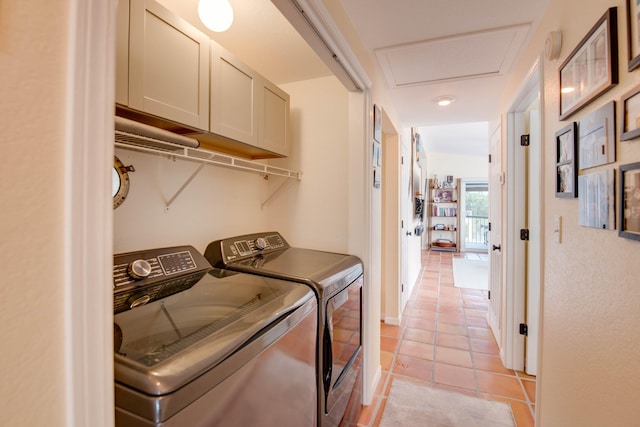 clothes washing area with cabinet space, attic access, light tile patterned flooring, independent washer and dryer, and baseboards