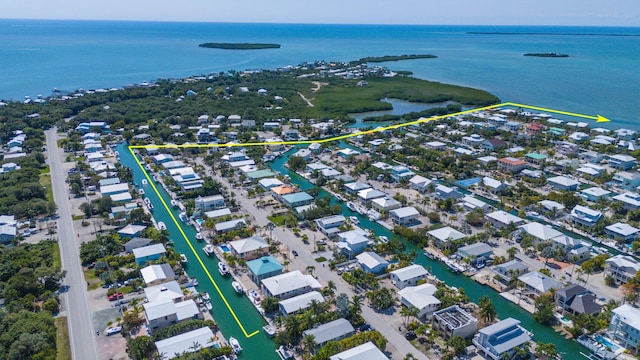 birds eye view of property with a water view and a residential view