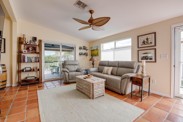 living area featuring a ceiling fan, visible vents, vaulted ceiling, and light tile patterned floors