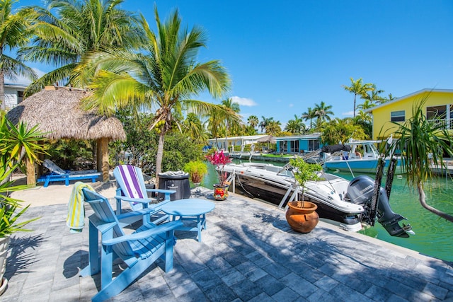 view of patio / terrace featuring a water view and a boat dock