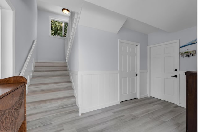 staircase with hardwood / wood-style flooring