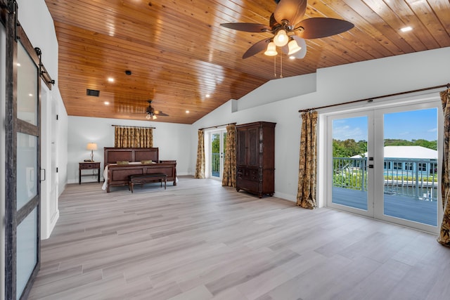 unfurnished room with a barn door, a healthy amount of sunlight, and wooden ceiling