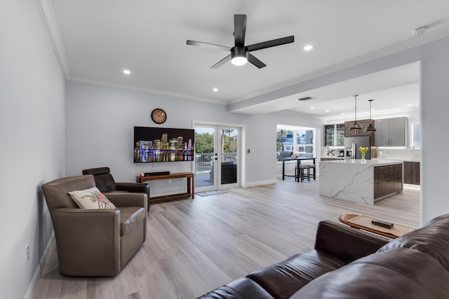 living room featuring french doors, ceiling fan, ornamental molding, and light hardwood / wood-style flooring