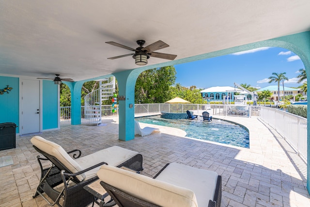 view of pool featuring pool water feature, ceiling fan, and a patio area