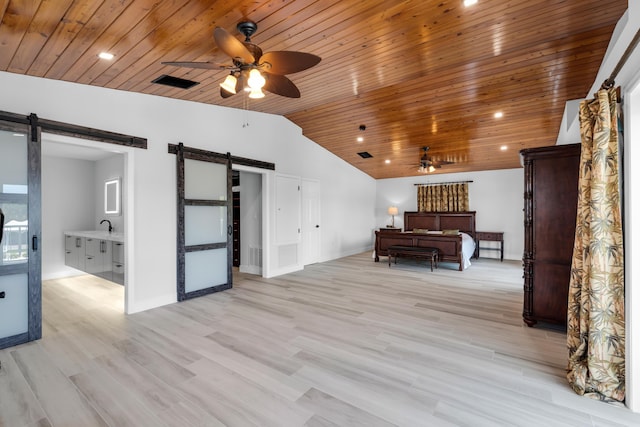 interior space featuring lofted ceiling, wood ceiling, light wood-type flooring, ceiling fan, and a barn door