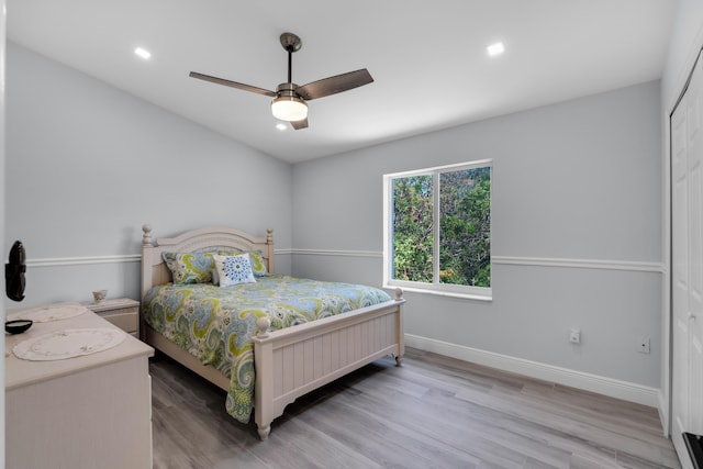 bedroom featuring a closet, ceiling fan, and light wood-type flooring