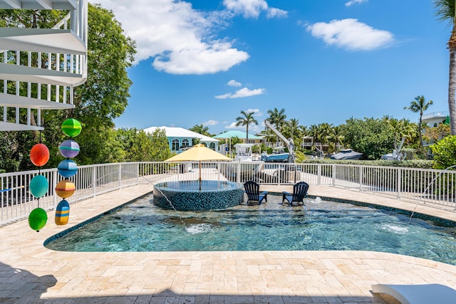 view of swimming pool with an in ground hot tub and pool water feature