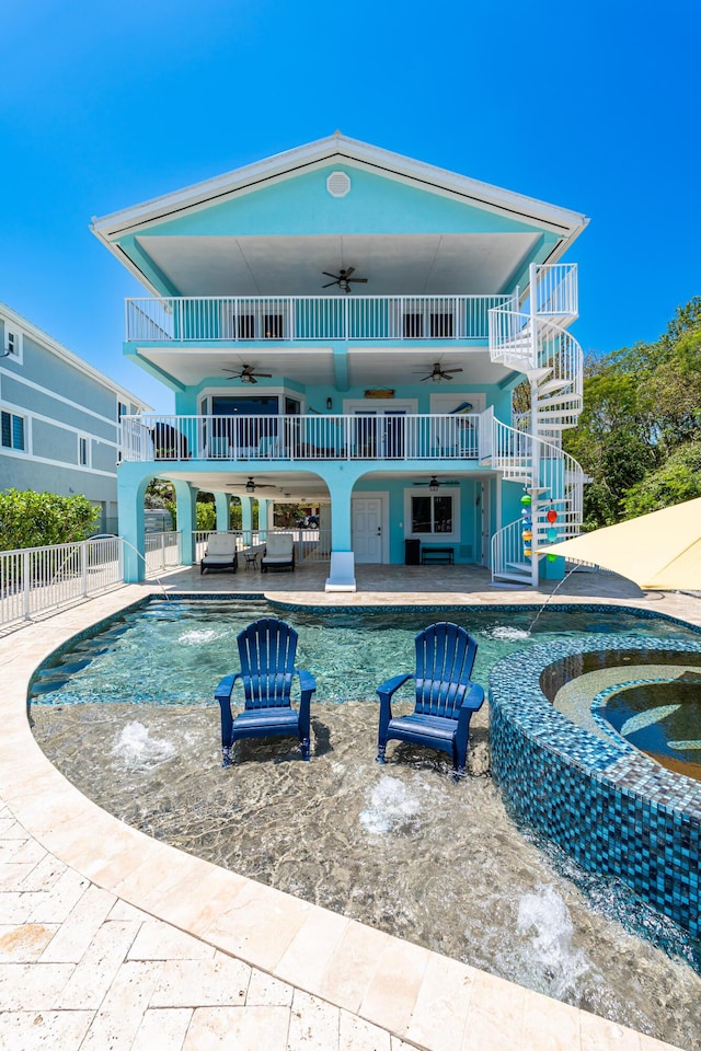 back of house with an outdoor living space, pool water feature, a patio, and ceiling fan