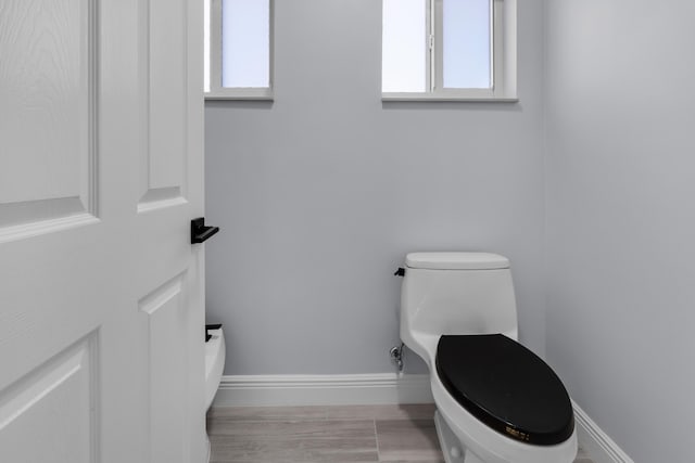 bathroom with wood-type flooring and toilet