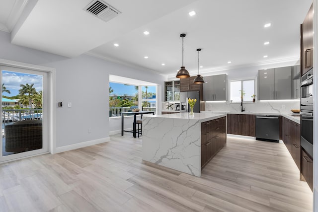 kitchen with pendant lighting, dishwashing machine, stainless steel fridge, backsplash, and a center island