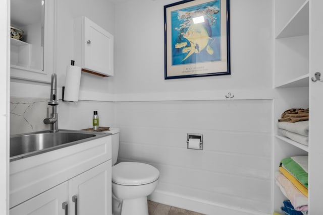 bathroom featuring tile patterned flooring, vanity, and toilet