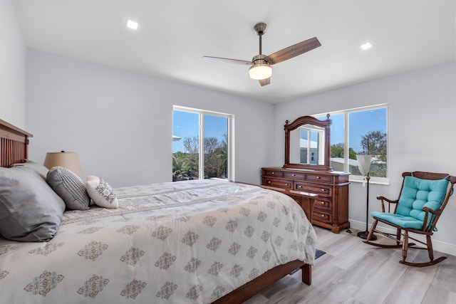 bedroom with ceiling fan and light hardwood / wood-style flooring