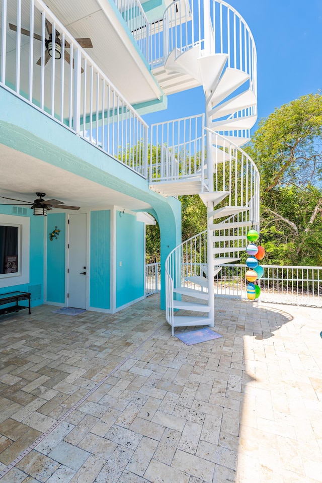 exterior space with ceiling fan