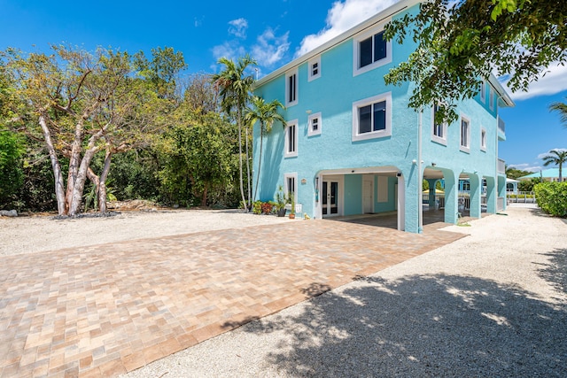 back of house with a carport