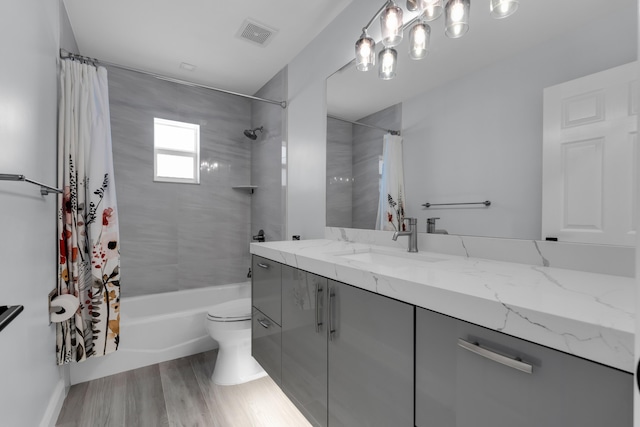 full bathroom featuring vanity, shower / tub combo, wood-type flooring, and toilet