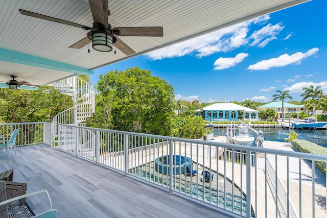 wooden deck featuring a water view and ceiling fan