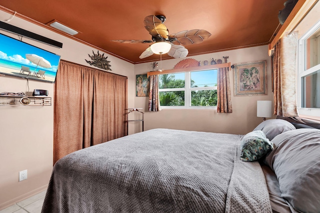 tiled bedroom featuring ornamental molding and ceiling fan