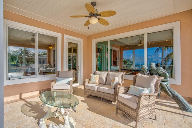 sunroom with wood ceiling and ceiling fan