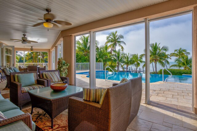 sunroom / solarium featuring plenty of natural light and ceiling fan