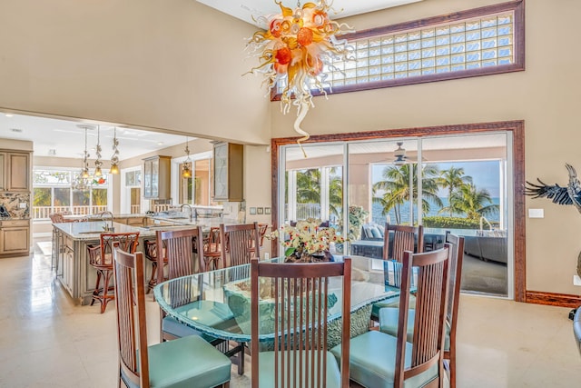 dining space featuring a high ceiling and a notable chandelier