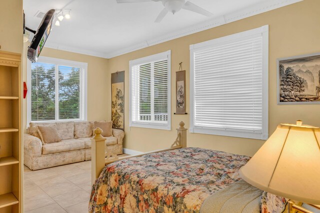 tiled bedroom featuring crown molding and ceiling fan