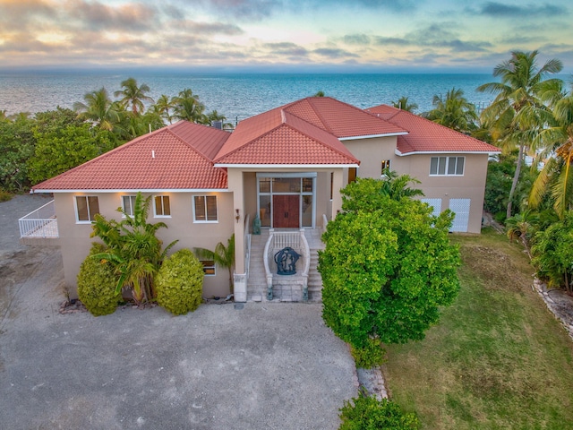 mediterranean / spanish-style house featuring a water view