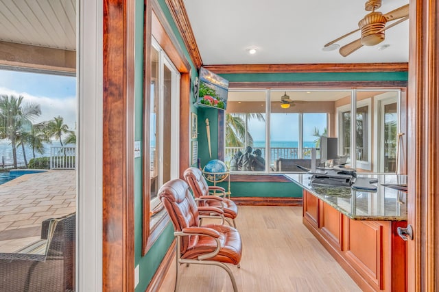 sunroom / solarium featuring ceiling fan