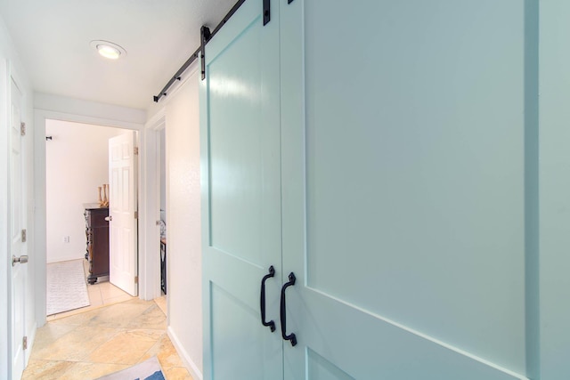 22988 Port Royal Ln, Cudjoe, FL 33042 - corridor with a barn door and baseboards