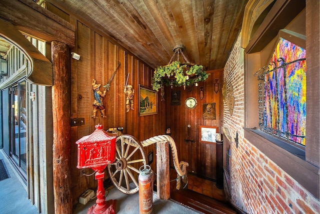 interior space with wood ceiling and wood walls