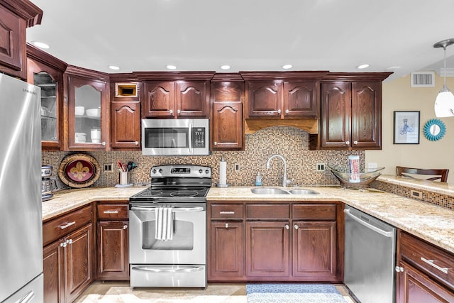 87465 Old Hwy Unit 106, Islamorada, FL 33036 - kitchen featuring stainless steel appliances, tasteful backsplash, hanging light fixtures, light stone countertops, and recessed lighting